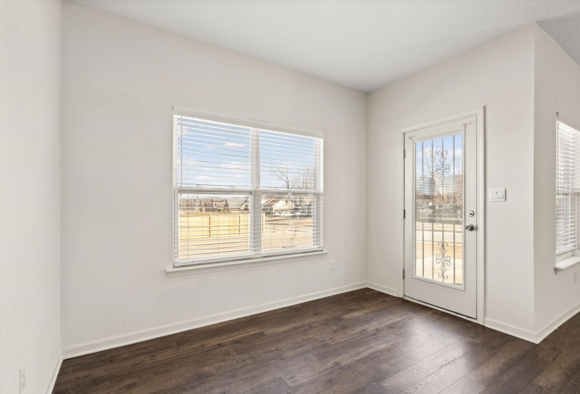 Doorway to outside featuring hardwood / wood-style flooring and baseboards