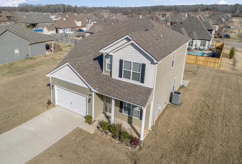 Traditional home with a shingled roof, a residential view, driveway, a porch, and an attached garage