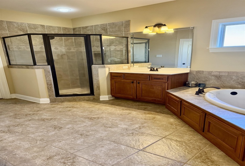 Full bath featuring a stall shower, vanity, a bath, and a chandelier