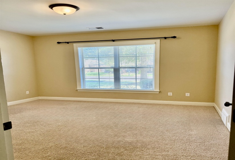 Empty room with carpet flooring and baseboards