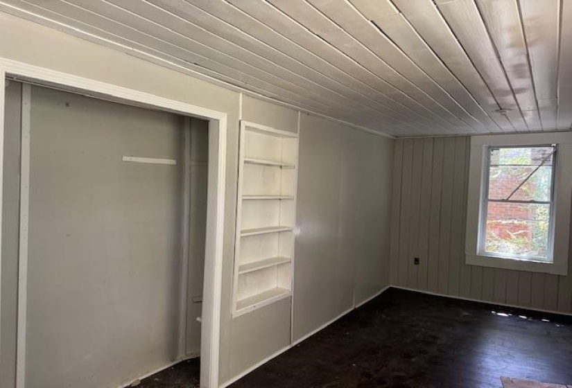 Unfurnished bedroom with wood ceiling and dark wood-type flooring
