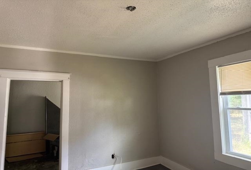 Spare room featuring crown molding and a textured ceiling