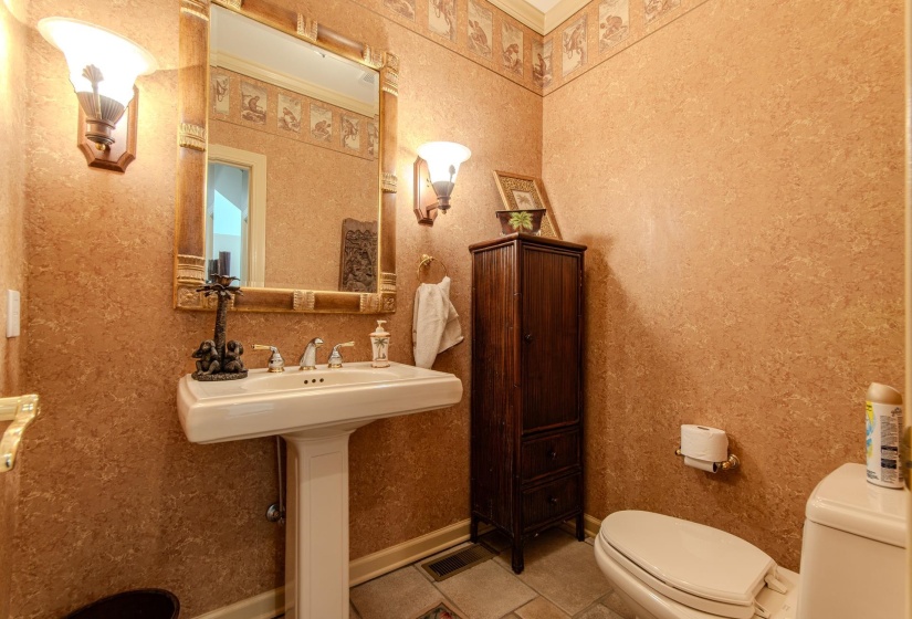 Half bathroom featuring toilet and tile patterned flooring