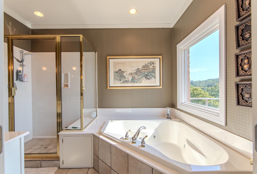 Bathroom with crown molding, wallpapered walls, a shower stall, a bath, and recessed lighting