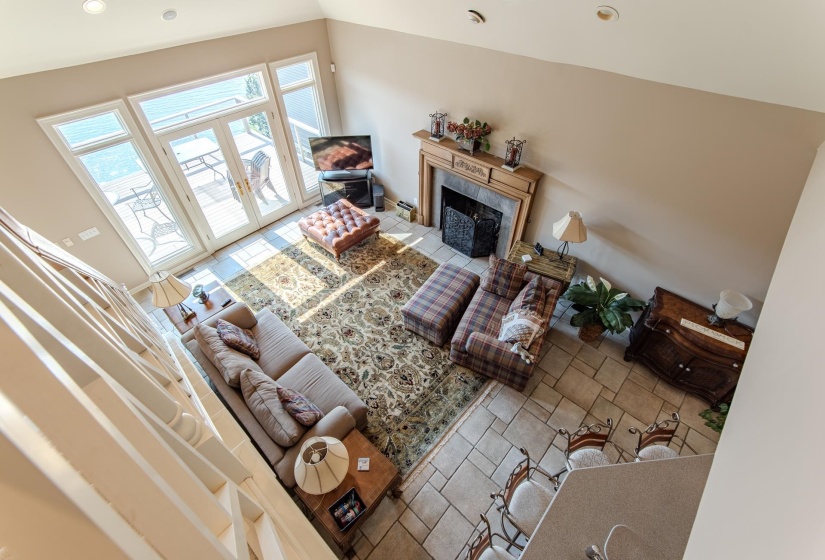 Tiled living room with french doors, recessed lighting, and a high end fireplace