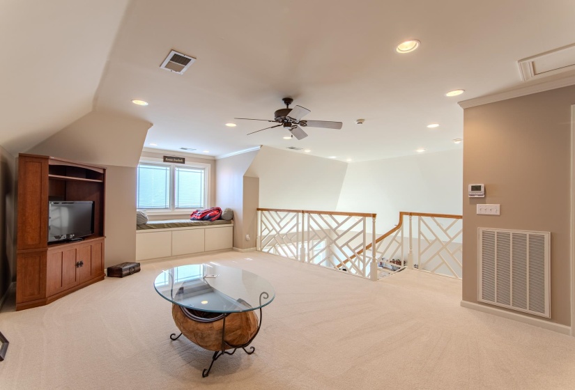 Sitting room with an upstairs landing, light carpet, recessed lighting, and ornamental molding