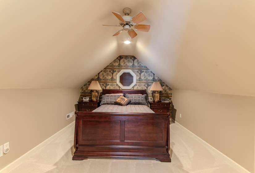 Bedroom with carpet floors, lofted ceiling, and ceiling fan
