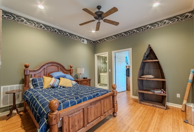 Bedroom with ornamental molding, light wood-style flooring, ceiling fan, connected bathroom, and recessed lighting