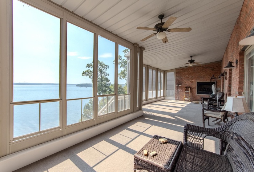 Sunroom / solarium featuring a water view and a ceiling fan