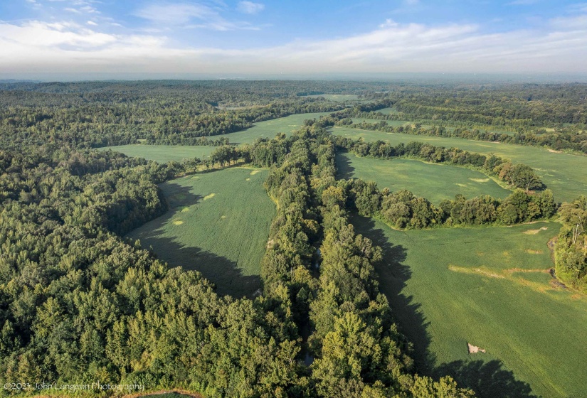Aerial view of property's location with a forest