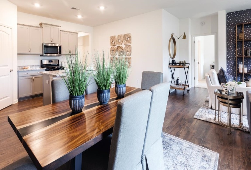 Dining room with dark wood finished floors and recessed lighting