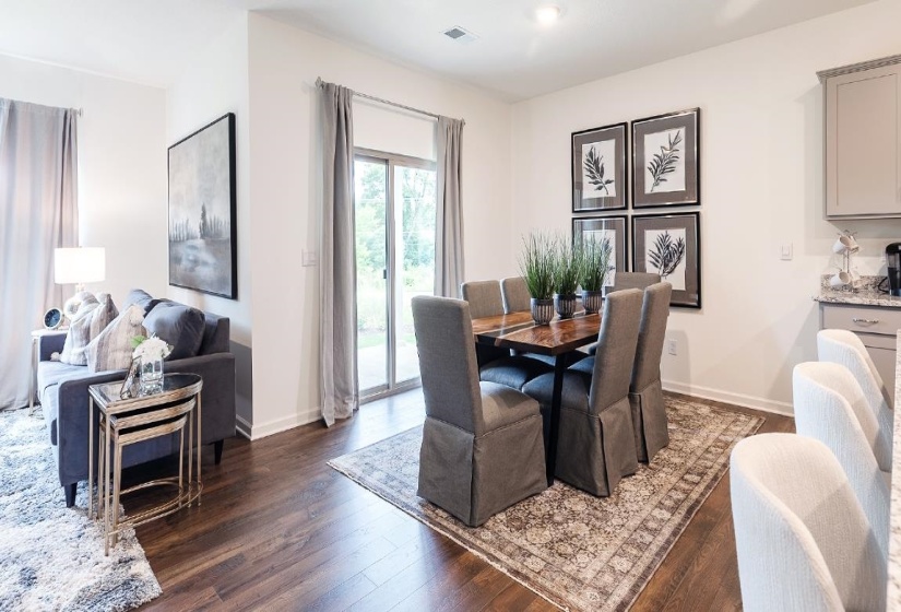 Dining space featuring dark wood-style floors and baseboards
