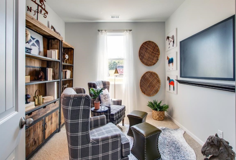 Sitting room featuring light colored carpet and baseboards
