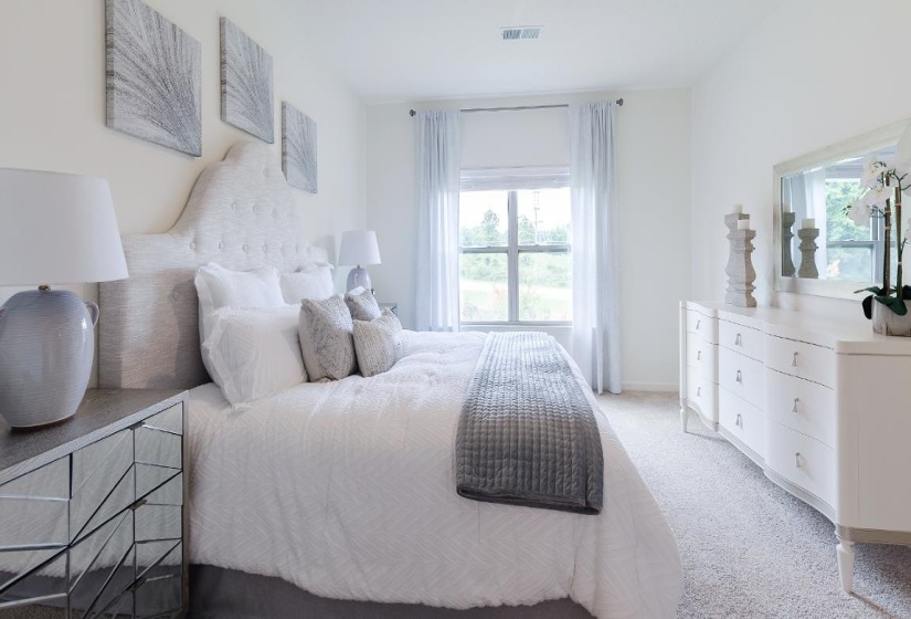 Carpeted bedroom featuring baseboards