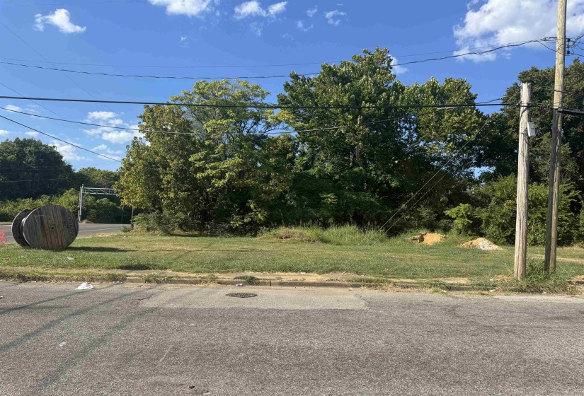 View of asphalt road featuring curbs