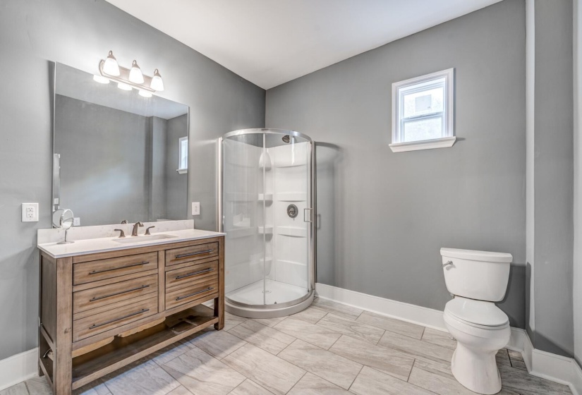 Full bath with vanity and a stall shower