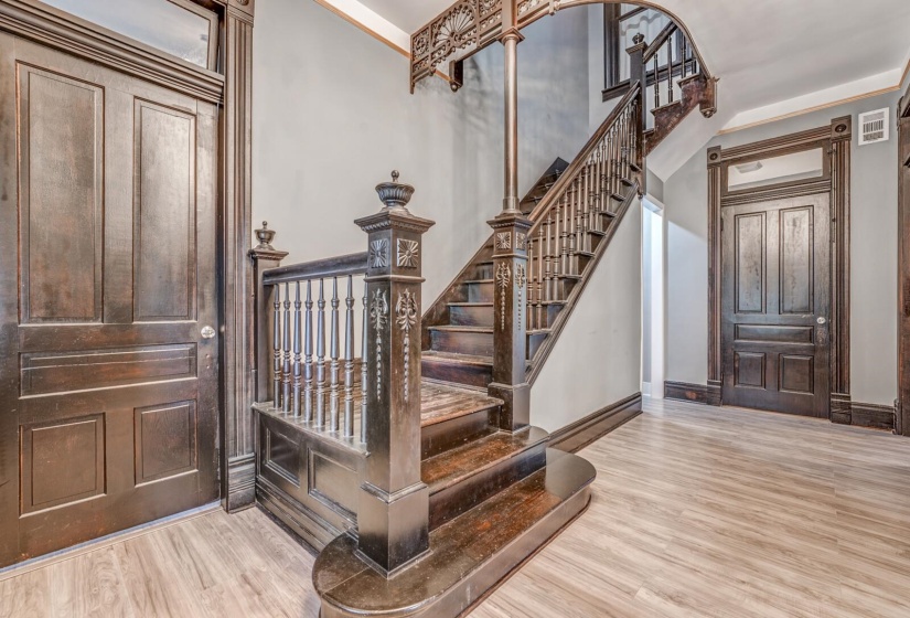 Entrance foyer with light wood-type flooring and stairway
