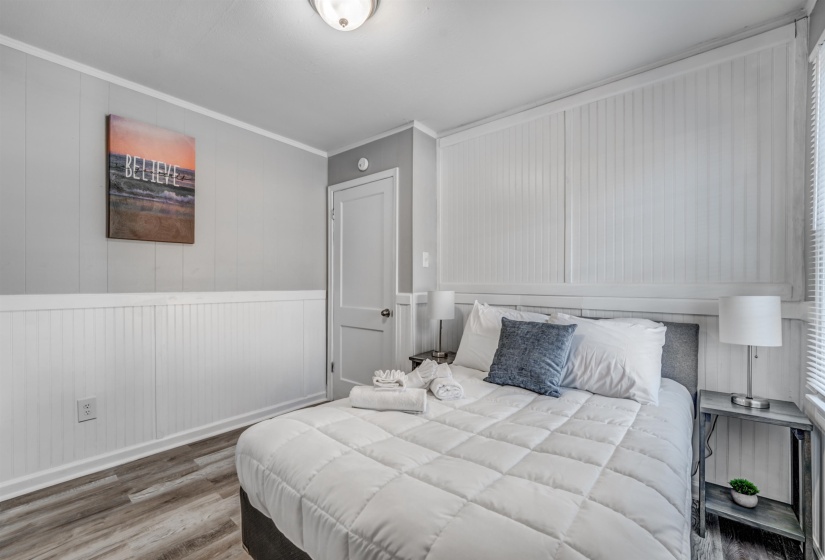 Bedroom featuring crown molding and hardwood / wood-style flooring