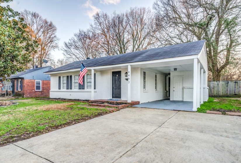 Ranch-style house with a carport and a front yard