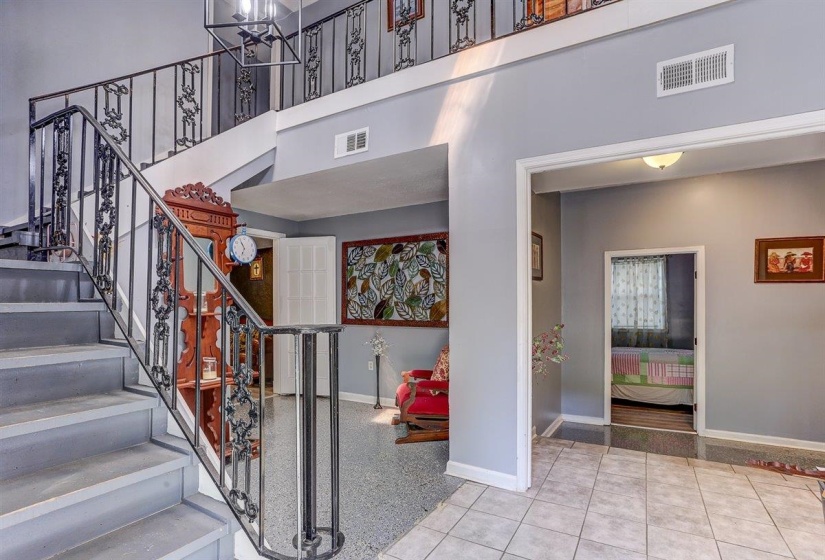 Stairs featuring a high ceiling and tile patterned flooring