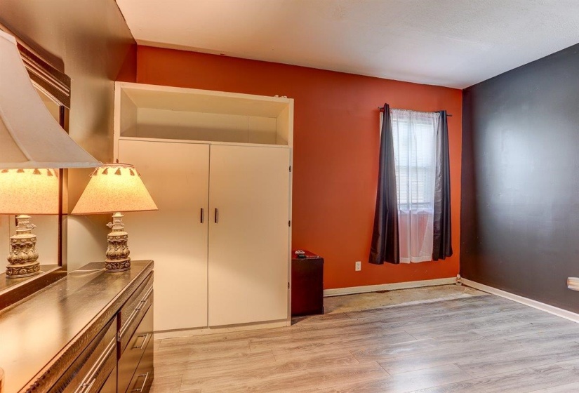 Bedroom with light wood-type flooring and baseboards
