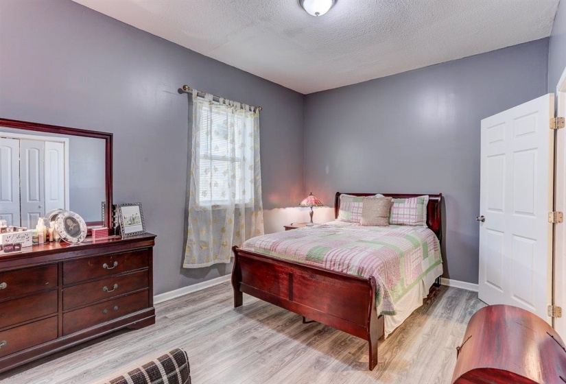 Bedroom featuring light wood finished floors and a textured ceiling