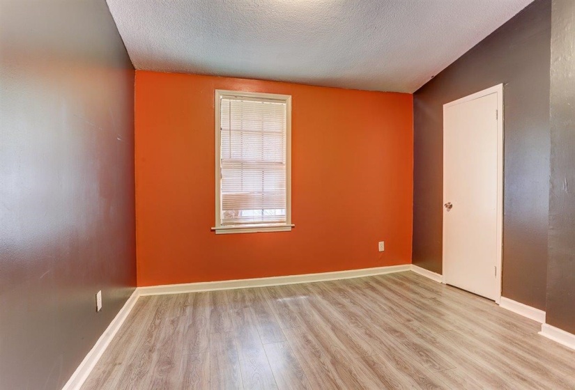 Unfurnished room with light wood-style floors and a textured ceiling