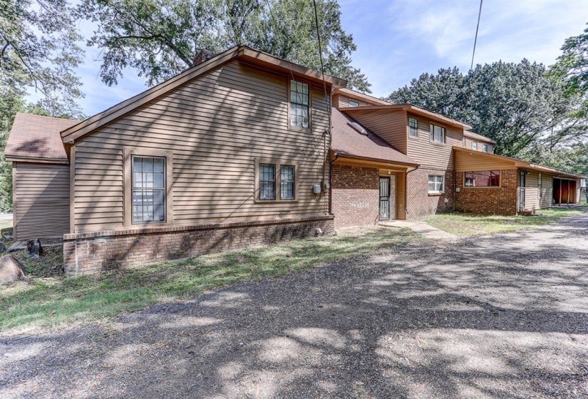 Rear view of property with brick siding