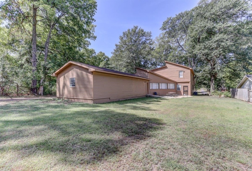 Rear view of house with view of wooded area