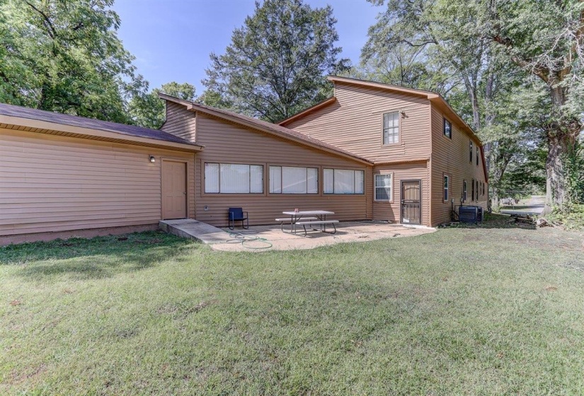 Rear view of property featuring a patio area and a yard