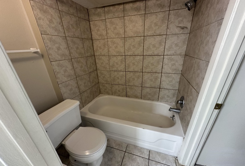 Full bath with shower / bathtub combination and tile patterned flooring
