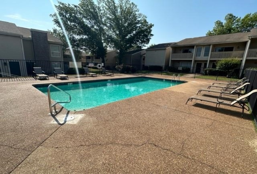 Community pool with a patio