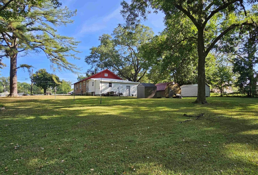 View of grassy yard with a shed