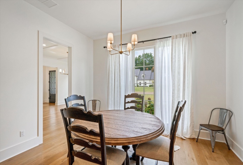 Breakfast area featuring a chandelier and light wood finished floors