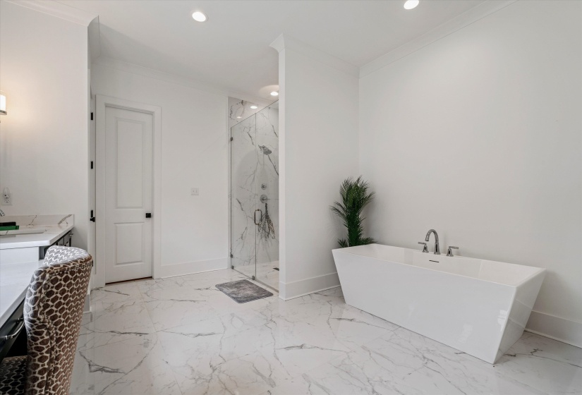 Bathroom with a marble finish shower, ornamental molding, a soaking tub, vanity, and recessed lighting