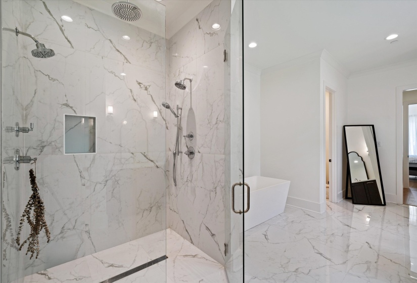 Bathroom featuring a marble finish shower, recessed lighting, crown molding, and light marble finish floors