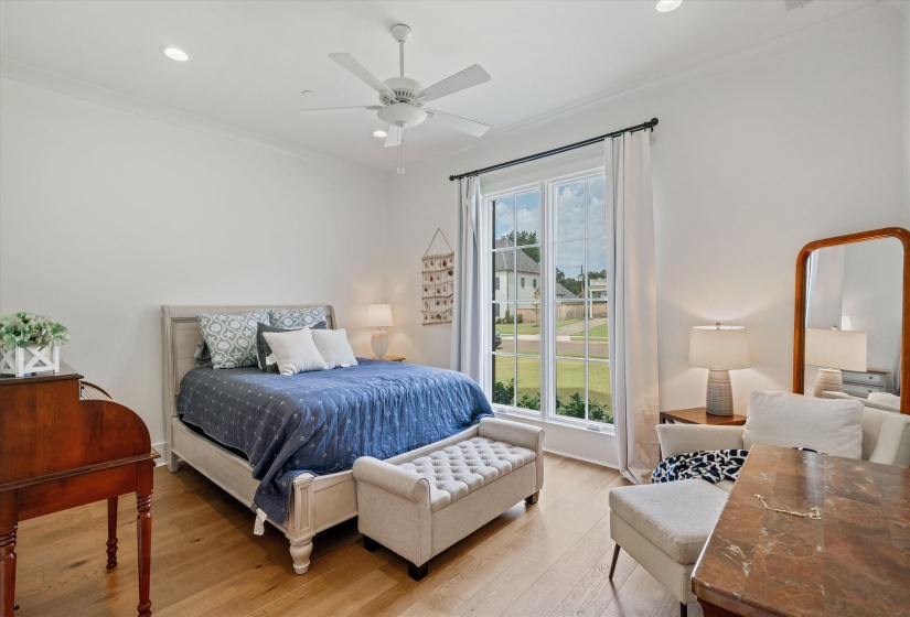 Bedroom with wood finished floors, recessed lighting, ceiling fan, and crown molding