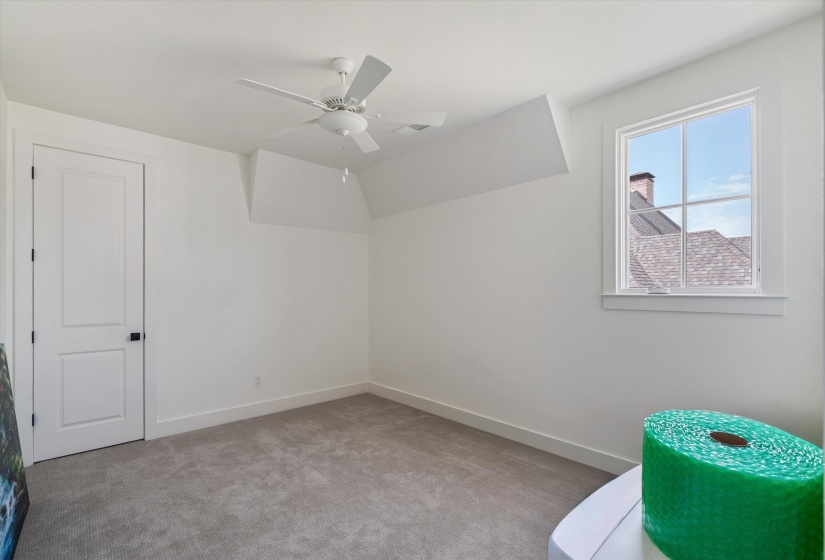 Located upstairs  room with carpet flooring and a ceiling fan