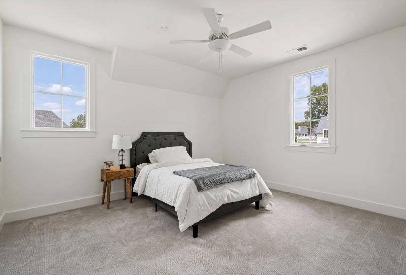 Bedroom featuring light carpet, a ceiling fan, and vaulted ceiling has a shared bath with bedroom #4