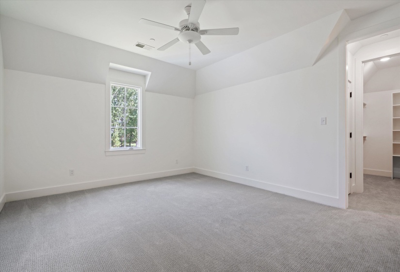 Bedroom #5  light colored carpet, ceiling fan and private connected full bathroom
