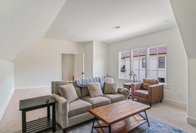 Bonus area featuring carpet floors, vaulted ceiling, and recessed lighting