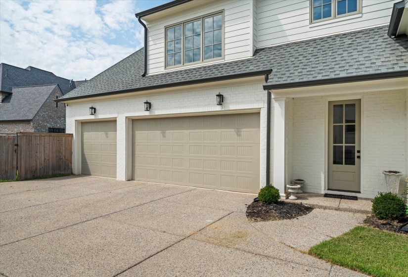 Garage featuring concrete driveway