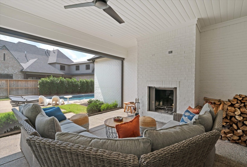 View of patio featuring an outdoor living space with a fireplace and ceiling fan