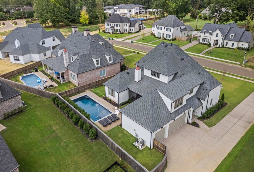 Aerial view of residential area featuring a pool area
