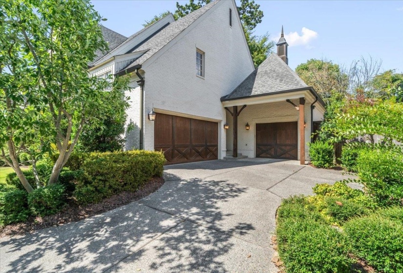 View of home's exterior featuring brick siding, concrete driveway, and roof with shingles