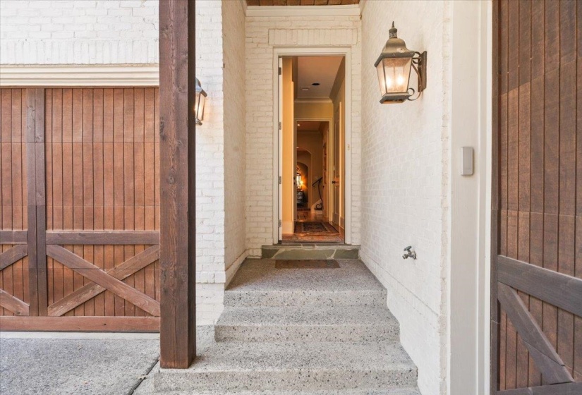 View of exterior entry featuring brick siding