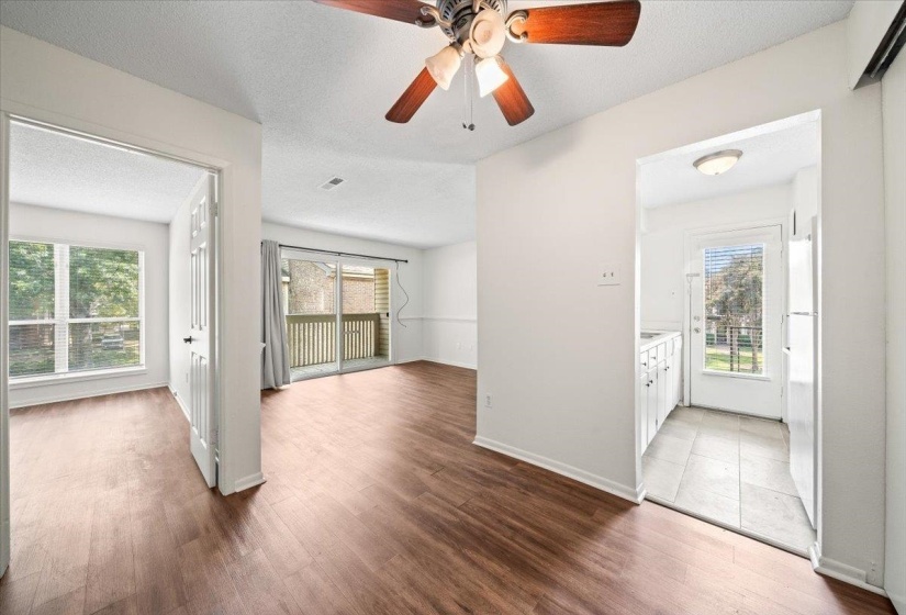 Empty room with ceiling fan, light wood-style floors, and a textured ceiling