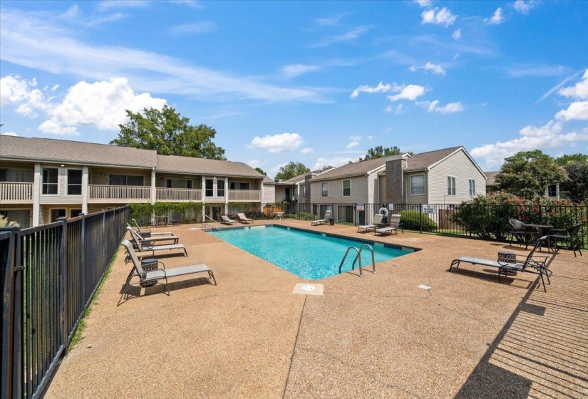 Community pool with a patio