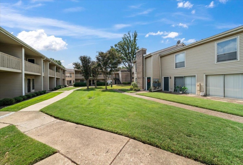 View of property's community featuring a lawn