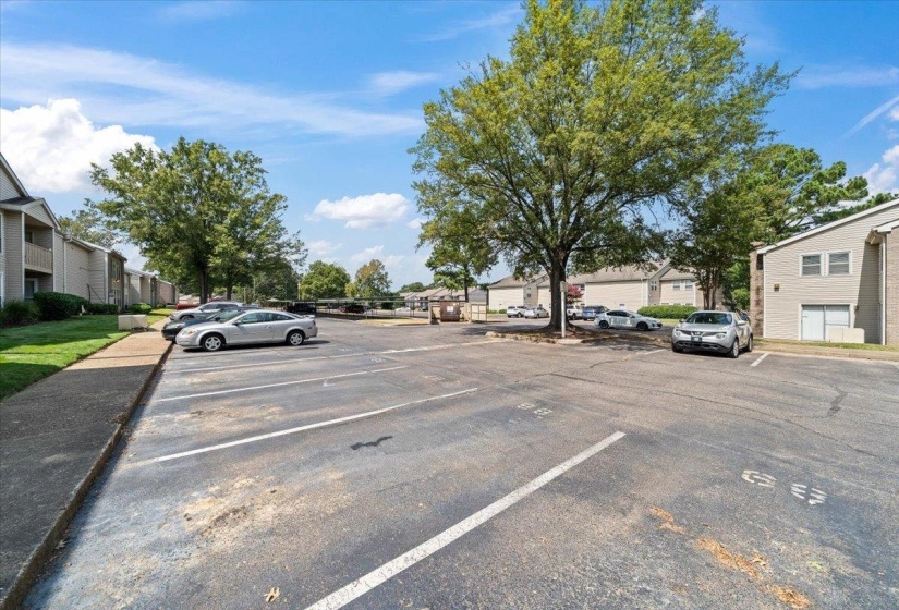 Uncovered parking lot featuring a residential view